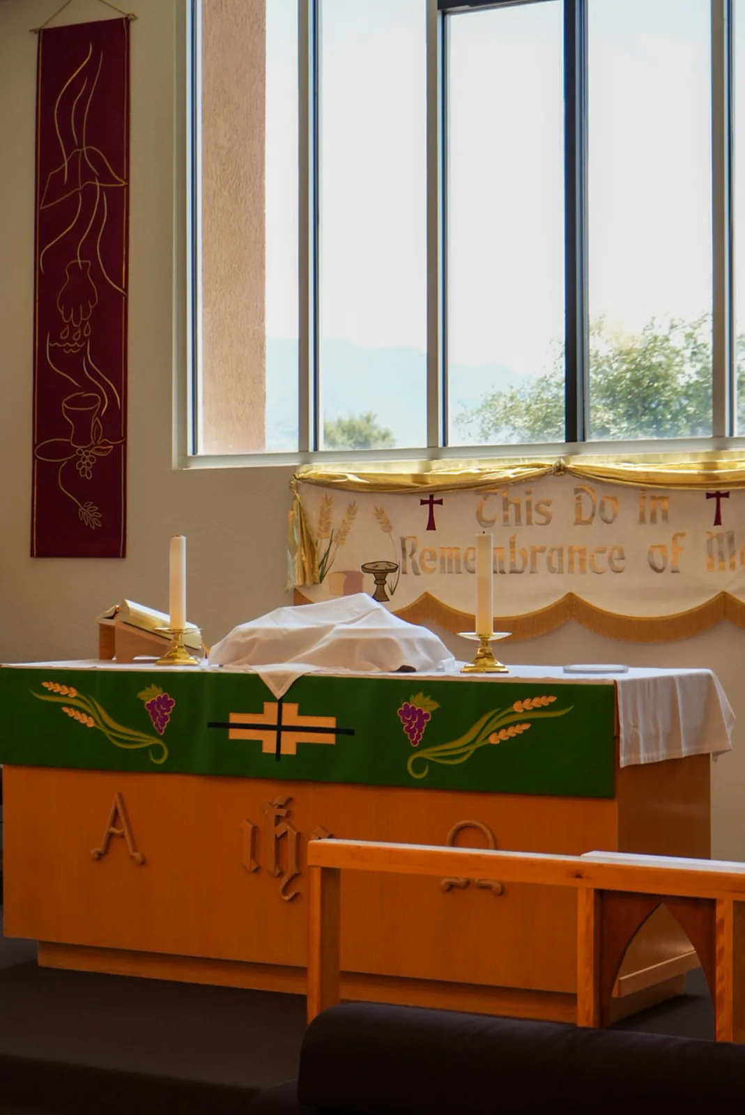 Altar set for Holy Communion with This Do in Remembrance of Me banner